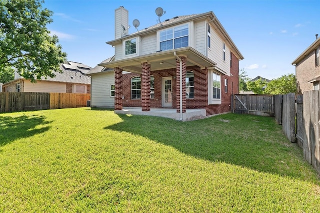 1006 Mesquite Hollow Pl, Round Rock, TX 78665 - rear view of property featuring a chimney, brick siding, and a patio