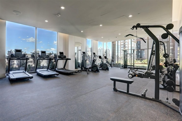 workout area with expansive windows and recessed lighting
