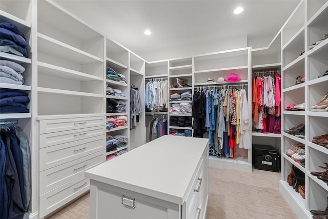 walk in closet featuring light colored carpet