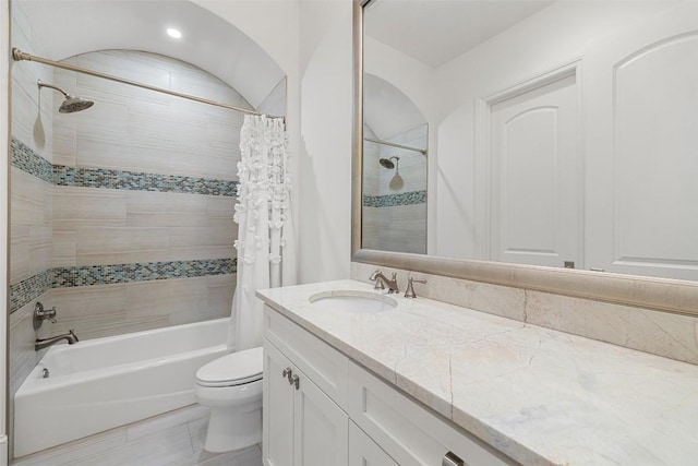 full bathroom featuring shower / tub combo with curtain, vanity, and toilet