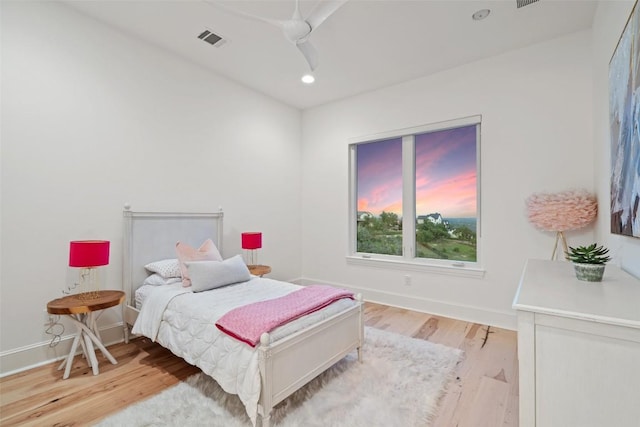 bedroom with recessed lighting, light wood-type flooring, visible vents, and baseboards