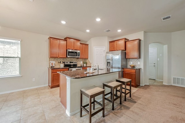 850 Hobby Rd, Copperas Cove, TX 76522 - kitchen featuring stainless steel appliances, arched walkways, backsplash, a breakfast bar, and recessed lighting