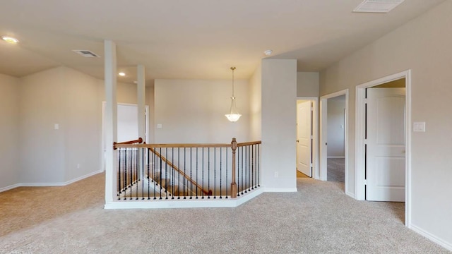 carpeted empty room featuring recessed lighting, visible vents, and baseboards