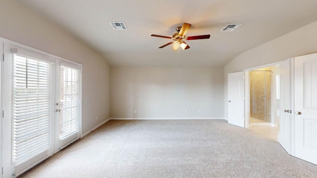 unfurnished bedroom with light carpet, vaulted ceiling, visible vents, and access to exterior