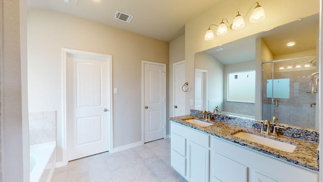 bathroom featuring a bath, a shower stall, a sink, and visible vents