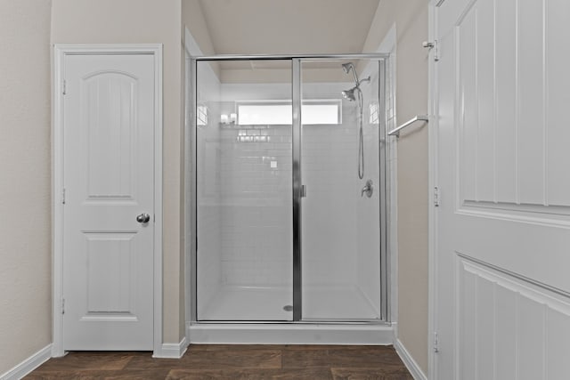 109 Rochester Ln, Hutto, TX 78634 - bathroom with a stall shower, baseboards, and wood finished floors