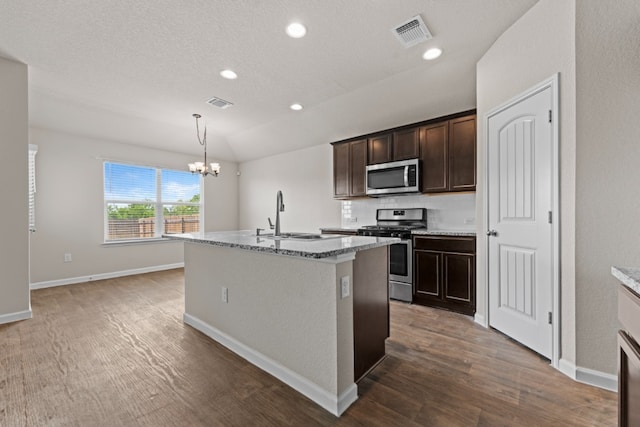 109 Rochester Ln, Hutto, TX 78634 - kitchen featuring appliances with stainless steel finishes, a sink, dark wood finished floors, a chandelier, and recessed lighting
