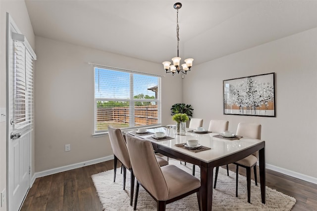 109 Rochester Ln, Hutto, TX 78634 - dining room featuring a chandelier, dark wood-type flooring, and baseboards