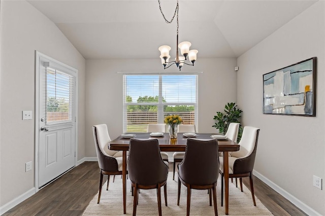 109 Rochester Ln, Hutto, TX 78634 - dining room with lofted ceiling, a chandelier, wood finished floors, and baseboards