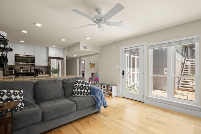 909 Reinli St Unit 104, Austin, TX 78751 - living room with recessed lighting, light wood-style floors, visible vents, and a ceiling fan