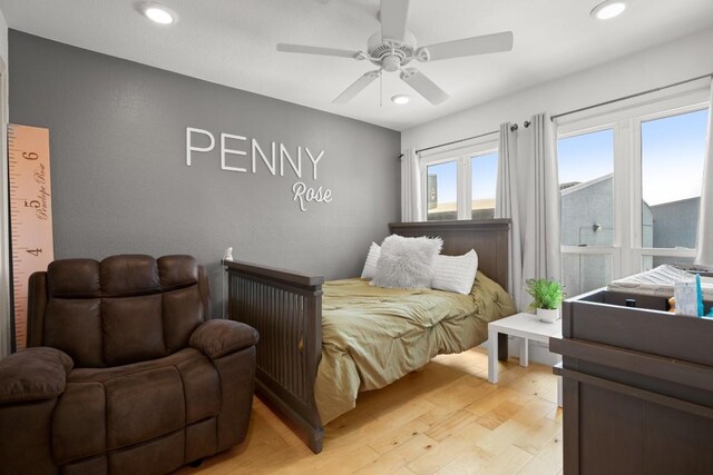 909 Reinli St Unit 104, Austin, TX 78751 - bedroom with light wood-type flooring, a ceiling fan, and recessed lighting