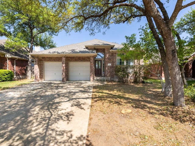 2101 Burnie Bishop Pl, Cedar Park, TX 78613 - view of front facade featuring an attached garage, brick siding, concrete driveway, a chimney, and roof with shingles