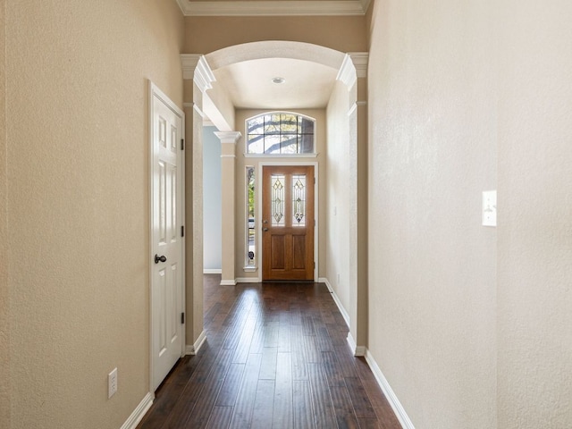 2101 Burnie Bishop Pl, Cedar Park, TX 78613 - entryway with arched walkways, dark wood-style floors, a textured wall, decorative columns, and ornamental molding