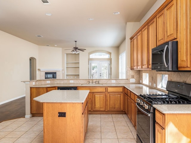2101 Burnie Bishop Pl, Cedar Park, TX 78613 - kitchen with appliances with stainless steel finishes, ceiling fan, a peninsula, a kitchen island, and tasteful backsplash