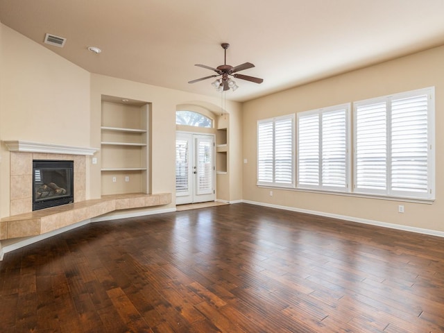 2101 Burnie Bishop Pl, Cedar Park, TX 78613 - unfurnished living room with a ceiling fan, built in features, hardwood / wood-style floors, and a fireplace
