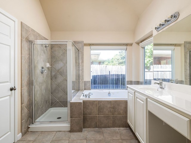 2101 Burnie Bishop Pl, Cedar Park, TX 78613 - bathroom with vaulted ceiling, vanity, a garden tub, a stall shower, and tile patterned floors