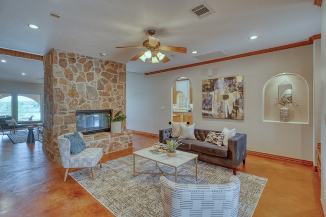 3320 River Oaks Dr, Kingsland, TX 78639 - living area with arched walkways, ceiling fan, recessed lighting, a fireplace, and ornamental molding