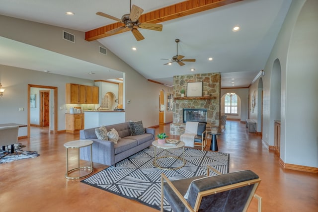3320 River Oaks Dr, Kingsland, TX 78639 - living area with arched walkways, ceiling fan, recessed lighting, concrete flooring, and a stone fireplace
