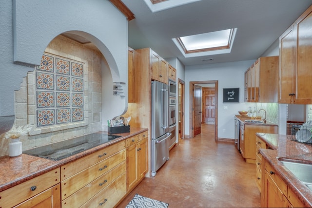 3320 River Oaks Dr, Kingsland, TX 78639 - kitchen with black electric stovetop, high quality fridge, arched walkways, tasteful backsplash, and concrete flooring
