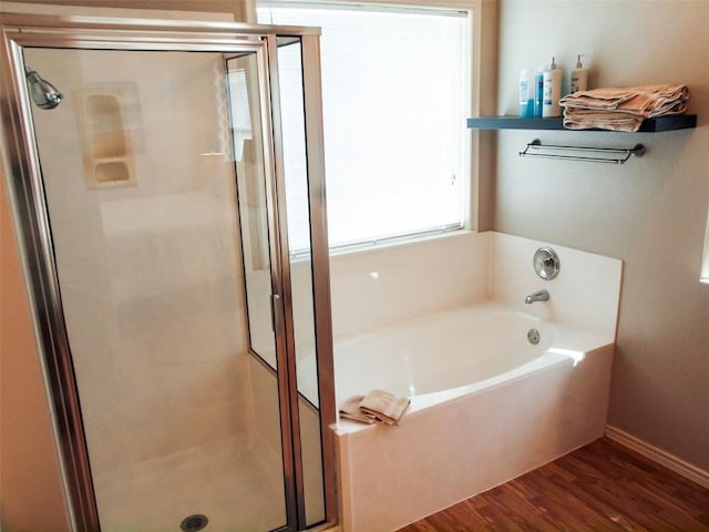 17300 Zola Ln, Round Rock, TX 78664 - full bathroom featuring a garden tub, a stall shower, and wood finished floors
