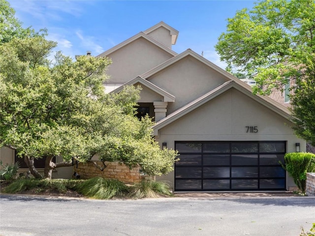 view of front of home with stucco siding and a garage