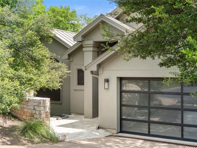 7115 Las Ventanas Dr, Austin, TX 78731 - doorway to property with a standing seam roof, stucco siding, and a metal roof