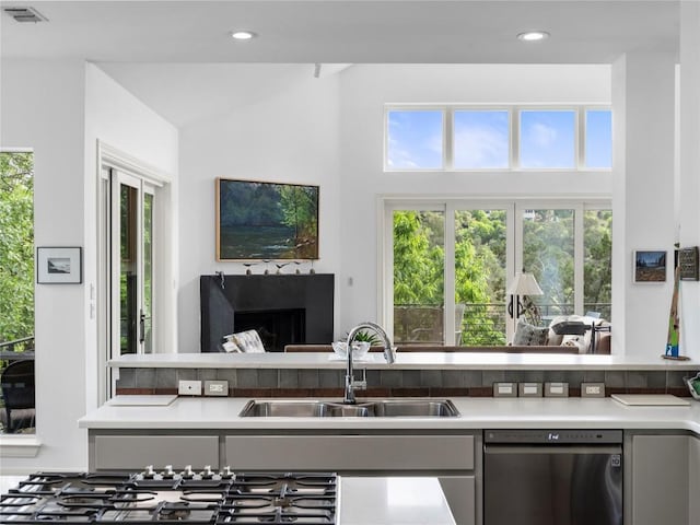 7115 Las Ventanas Dr, Austin, TX 78731 - kitchen with stainless steel appliances, gray cabinetry, light countertops, recessed lighting, and vaulted ceiling