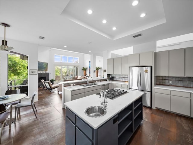 7115 Las Ventanas Dr, Austin, TX 78731 - kitchen featuring appliances with stainless steel finishes, recessed lighting, a center island, healthy amount of natural light, and gray cabinetry