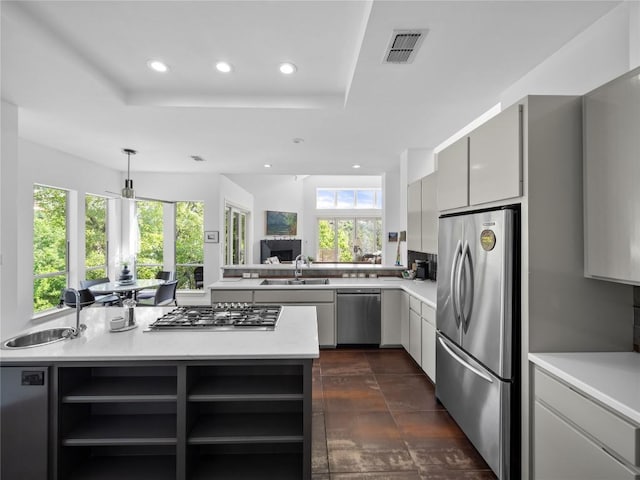 7115 Las Ventanas Dr, Austin, TX 78731 - kitchen featuring appliances with stainless steel finishes, recessed lighting, open shelves, light countertops, and a tray ceiling
