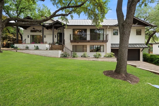 4828 Timberline Dr, Austin, TX 78746 - view of front of property featuring a standing seam roof, a metal roof, an attached garage, and stucco siding