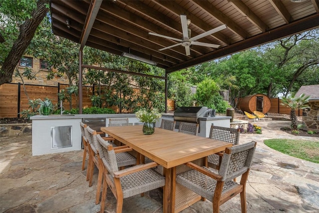 4828 Timberline Dr, Austin, TX 78746 - fenced backyard with an outdoor kitchen, a patio area, outdoor dining space, and a ceiling fan