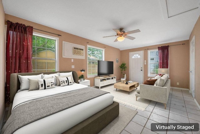 bedroom featuring a ceiling fan, light tile patterned flooring, multiple windows, and a wall mounted AC