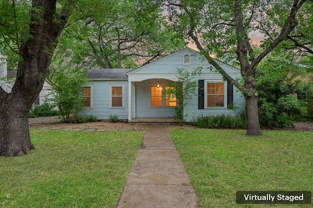 view of front of home with a lawn and covered porch