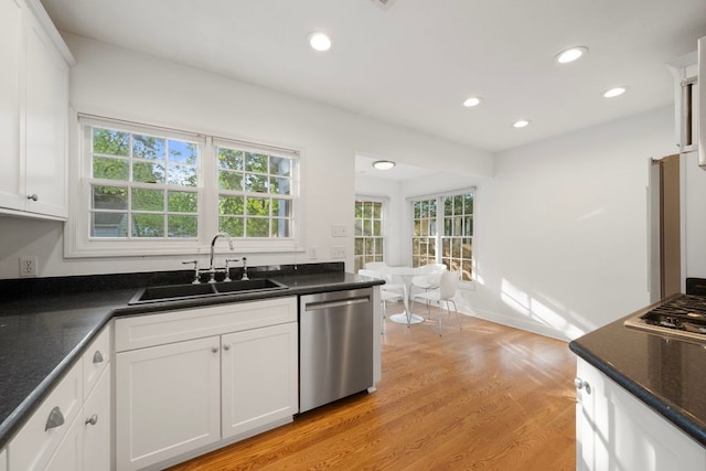 kitchen with white cabinets, a healthy amount of sunlight, appliances with stainless steel finishes, and a sink