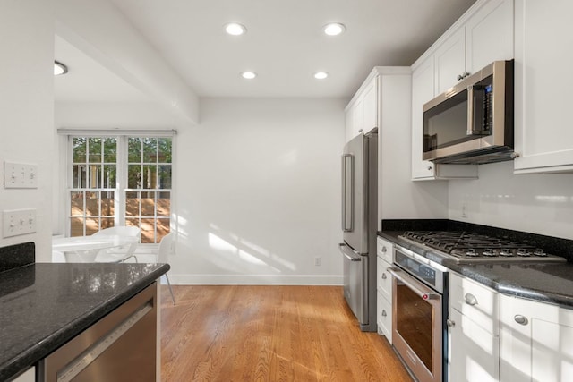 kitchen featuring recessed lighting, white cabinetry, stainless steel appliances, and light wood-style flooring