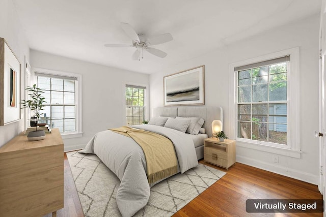 bedroom featuring ceiling fan, baseboards, and light wood-type flooring