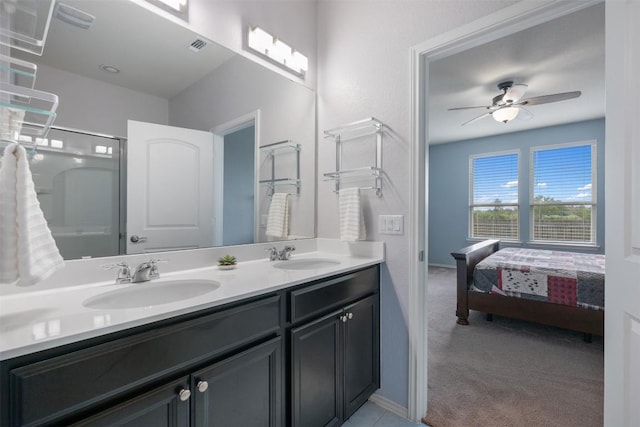 713 Hummingbird Ln, Leander, TX 78641 - ensuite bathroom featuring double vanity, a shower, and a ceiling fan