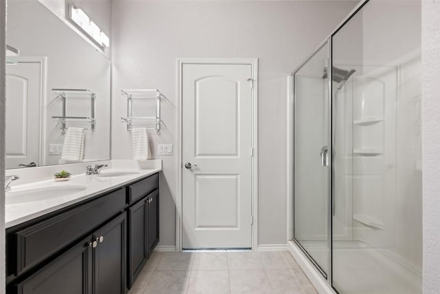 713 Hummingbird Ln, Leander, TX 78641 - bathroom with a shower stall, double vanity, and tile patterned flooring
