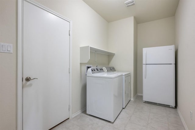 713 Hummingbird Ln, Leander, TX 78641 - laundry room featuring washing machine and dryer and baseboards