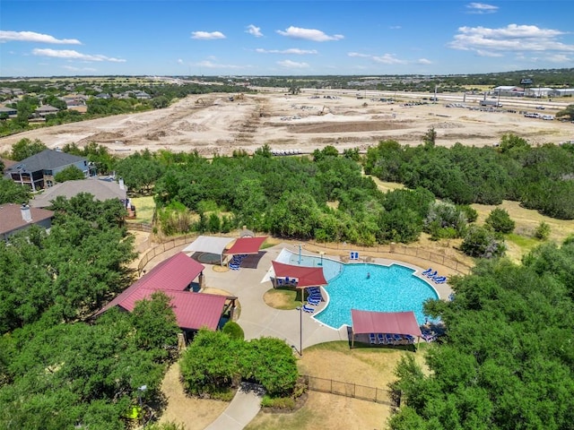 713 Hummingbird Ln, Leander, TX 78641 - drone / aerial view of a pool and a tree filled landscape