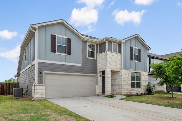 713 Hummingbird Ln, Leander, TX 78641 - view of front of property featuring stone siding, board and batten siding, a garage, and driveway