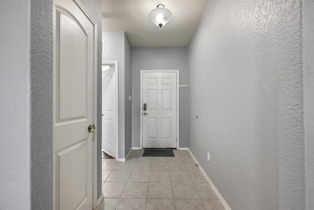 713 Hummingbird Ln, Leander, TX 78641 - entryway featuring a textured wall and light tile patterned flooring