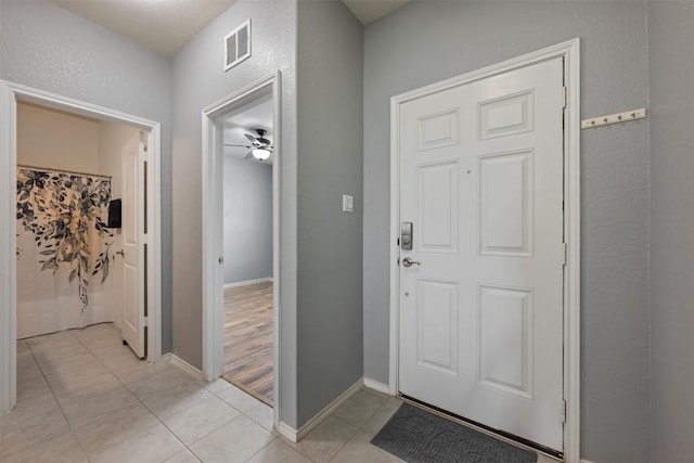 713 Hummingbird Ln, Leander, TX 78641 - foyer entrance featuring light tile patterned floors and ceiling fan
