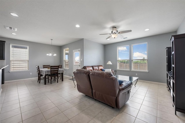713 Hummingbird Ln, Leander, TX 78641 - living room featuring healthy amount of natural light, ceiling fan, recessed lighting, a chandelier, and light tile patterned floors