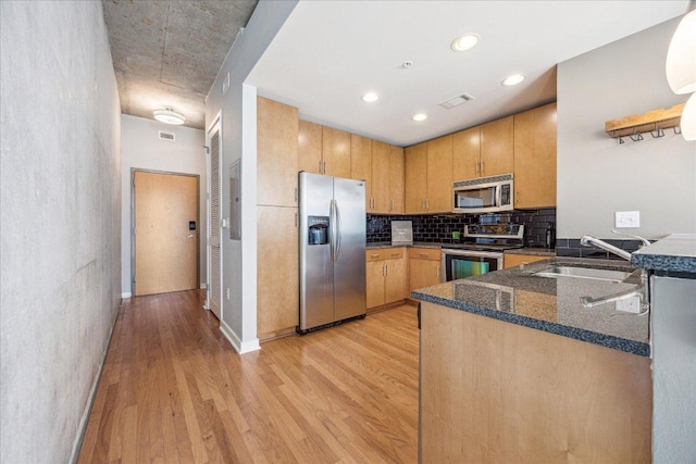 360 Nueces St Unit 1208, Austin, TX 78701 - kitchen featuring stainless steel appliances, light wood-style flooring, tasteful backsplash, dark stone countertops, and recessed lighting