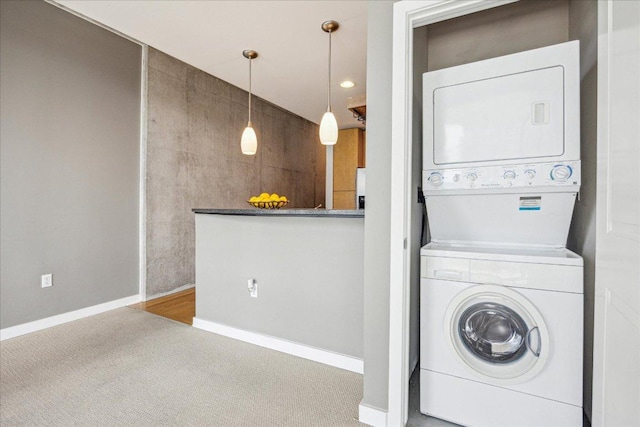360 Nueces St Unit 1208, Austin, TX 78701 - laundry area featuring stacked washer and clothes dryer and carpet flooring