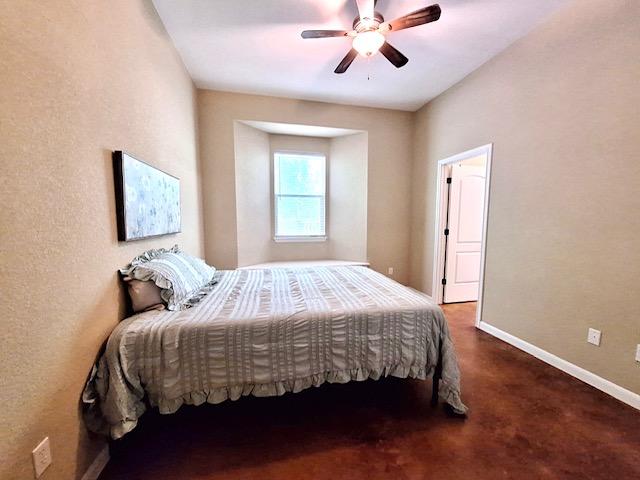 bedroom with baseboards and ceiling fan