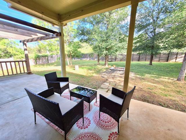 view of patio featuring an outdoor living space and a fenced backyard