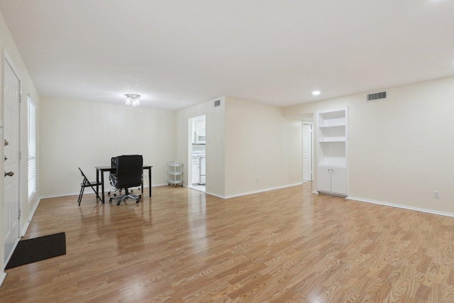 2401 Leon St Unit 210, Austin, TX 78705 - living area featuring light wood-style floors, baseboards, built in features, and recessed lighting