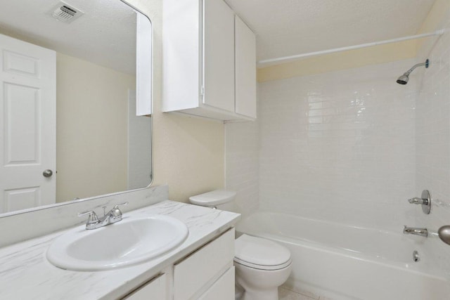 bathroom featuring a textured ceiling, visible vents, vanity, toilet, and washtub / shower combination